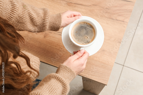 Woman holding cup of coffee...