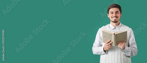 Young man reading book on g...