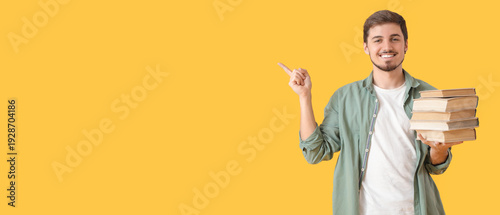 Young man with stack of boo...