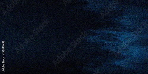 Abstract dark blue denim fabric texture with a rough cotton surface and glowing particles on a deep cloth background