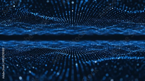 A dark blue image shows flowing, wave-like shapes composed of small, shimmering, luminescent particles. Vertical lines create the effect