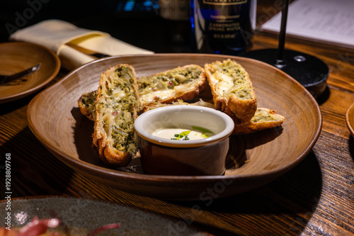 Crispy baked breadsticks filled with vibrant green pesto and melted cheese, perfectly paired with a creamy dipping sauce, creating a delicious and inviting appetizer for any meal