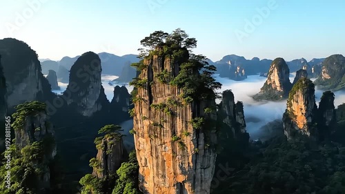 Breathtaking Aerial View of Wulingyuan Quartzite Sandstone Pillars: Zhangjiajie National Forest Park with Morning Mist and Lush Greenery