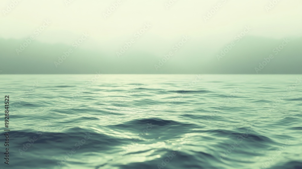 Obraz premium Gentle waves form on the serene sea surface under a soft, hazy sky, evoking tranquility and vastness.