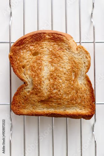 Golden Toast Bread on Wire Rack Isolated on White Background.