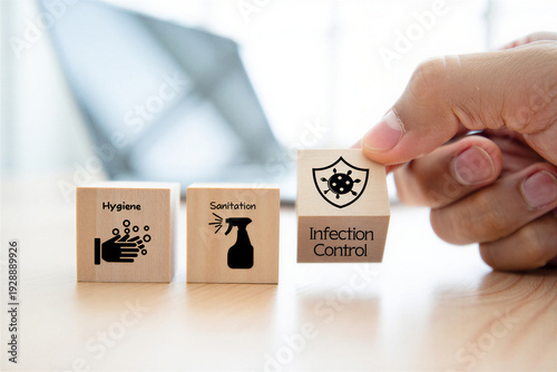 Hand holding wooden blocks symbolizing hygiene sanitation and infection control against viruses and bacteria for health awareness