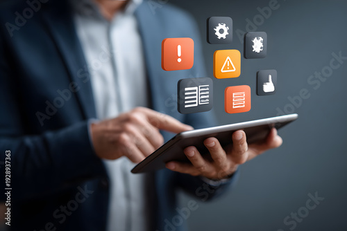 A businessman interacting with technology, a tablet displaying application icons. The image captures a man using a digital tablet with several icons hovering above it.