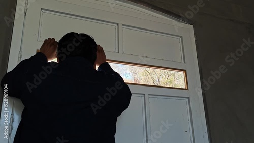 Man slamming door in frustration at window
