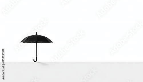 Minimal black umbrella silhouette on white background, simplicity concept