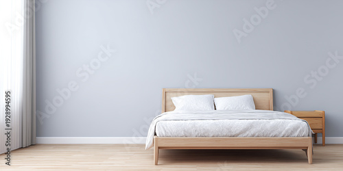 A minimalist bedroom with a light wood bed frame, white bedding, and a light blue wall.