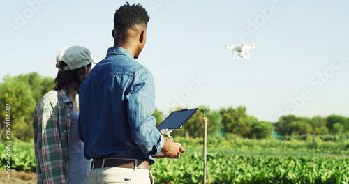 Quadro su tela Agriculture, farm and couple with drone for field mapping, monitor crops and space in nature