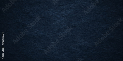 A dark blue denim fabric texture with a rough cotton material surface and grunge paper pattern creates a deep textile backdrop for fashion design wallpaper