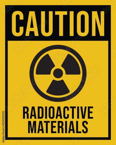 Warning sign featuring yellow rectangular background with black border radioactive symbol and bold text indicating hazardous materials safety alert