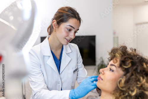 Cuadro en lienzo Professional dermatologist examining young woman's face in aesthetic clinic