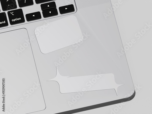 A close-up view of a laptop's keyboard and touchpad area with a protective skin featuring a speech bubble design