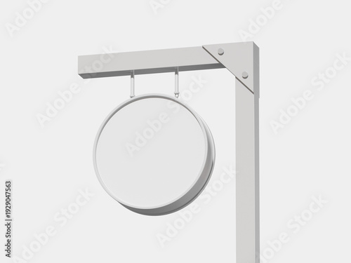 A white sign holder with a circular sign hanging from a metal bracket