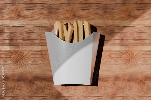 Tableau sur toile A white paper container filled with golden-brown fries on a wooden surface with