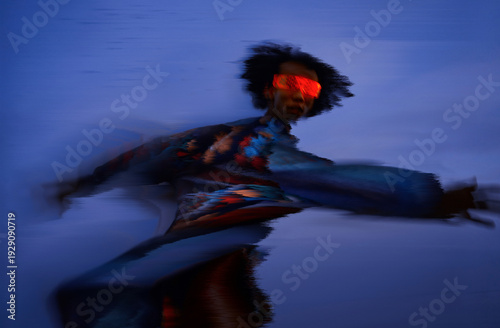 Man in motion with VR set under surreal light in cyberspace