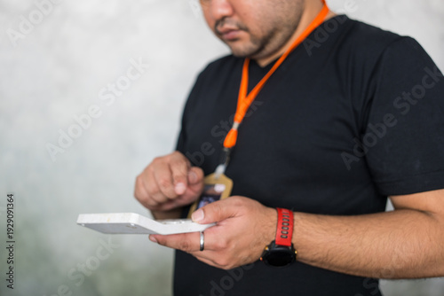 Wallpaper Mural An Asian officer is using a calculator. Employee works Torontodigital.ca