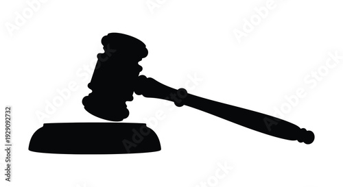 A stark black silhouette of a traditional gavel resting on a sound block representing legal authority and justice silhouette