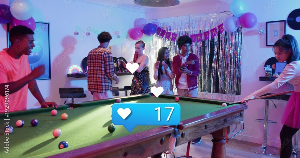 Fototapeta premium Playing friends leaning around green-felt pool table in rec room, woman in pink t-shirt holding cue