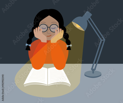 Girl reading a book or studying under a desk lamp.