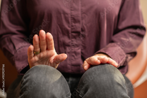 Woman practicing EMDR self tapping by alternating leg movements. Highlights bilateral stimulation, rhythmic control, and emotional self-regulation.