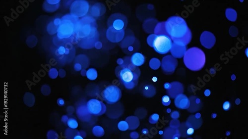 Vibrant blue bokeh lights create a magical and festive abstract background.