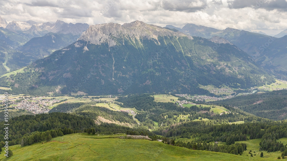 Fototapeta premium Aerial, bird view, vie winto valley near Rotwandhütte, Rifugio Roda di Vaèl mountain hut in Italian Dolomites. Wonderful hiking destination. Some hikers, tourists standing on the rocky top. Outdoor tr