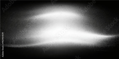 A polished silver stainless steel plate features a brushed metal texture with a shiny metallic surface and light gray reflections on a dark aluminum backdrop pattern