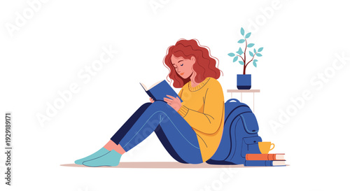 Young woman with curly hair sits on the floor leaning against her blue backpack while quietly reading a book in a white room.