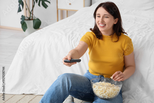 Young woman with remote con...