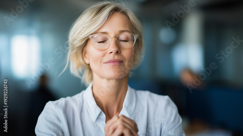 Faceless corporate woman in meditation at office, workplace mindfulness professional stress management, business wellness practice, calm office moment, defocused background, with copy space