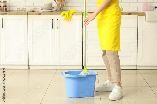 Young woman with bucket and...