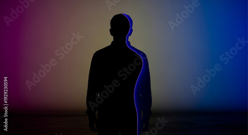 Silhouette of a person standing, illuminated by colorful lights, mysterious and intriguing.