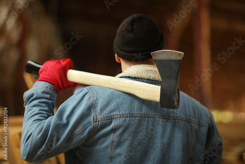 Male carpenter with axe at ...