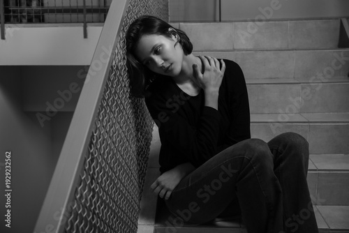 Depressed young woman sitti...