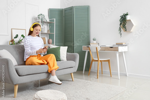 Young woman in headphones u...