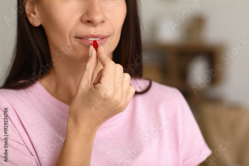 Woman taking pills at home....