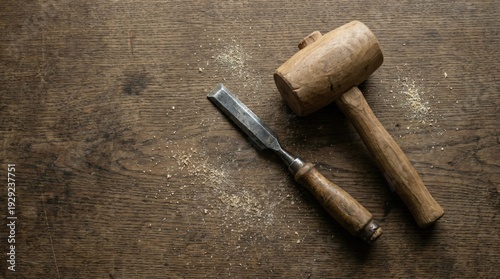 Wooden mallet and chisel on a rustic wooden surface