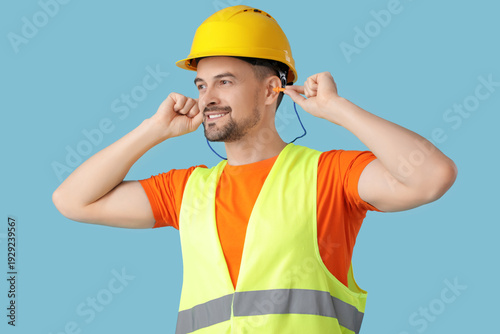 Male builder putting in ear...