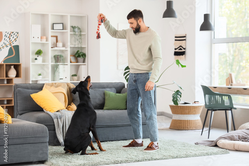 Young man playing with Dobe...