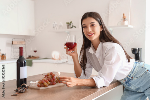 Young woman with glass of w...