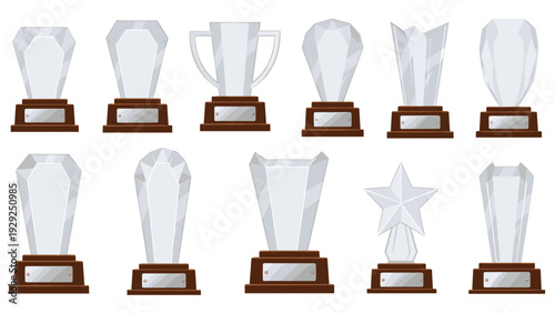 Collection of various glass and crystal award trophies with elegant wooden bases and blank silver nameplates for recognition.