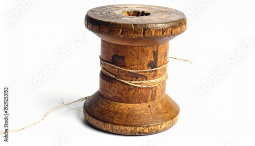Rustic wooden spool for thread or cable on a clean white background, showcasing aged texture and simple design, ideal for craft, vintage, or textile themes