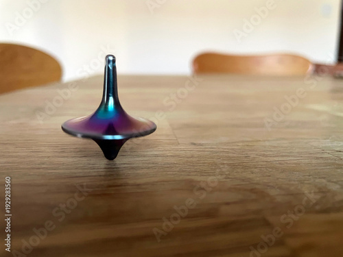 Metal spinning top on a wooden table