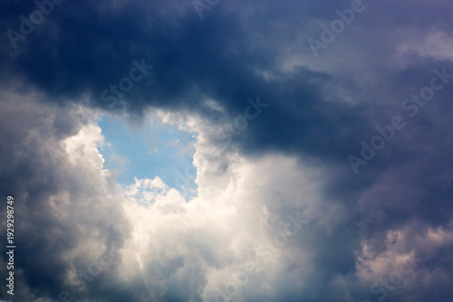 Gray rain clouds and blue sky in summer day.
