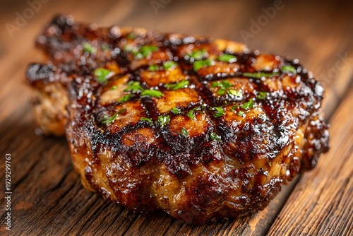 Grilled pork chop with herbs on wood.