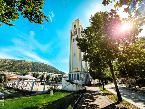Bild auf Leinwand Franciscan church tower in Mostar, Bosnia and Herzegovina surrounded by trees