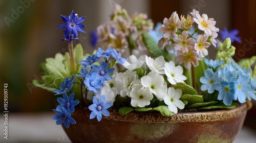 Beautiful spring flowers in vintage bronze pot arrangement